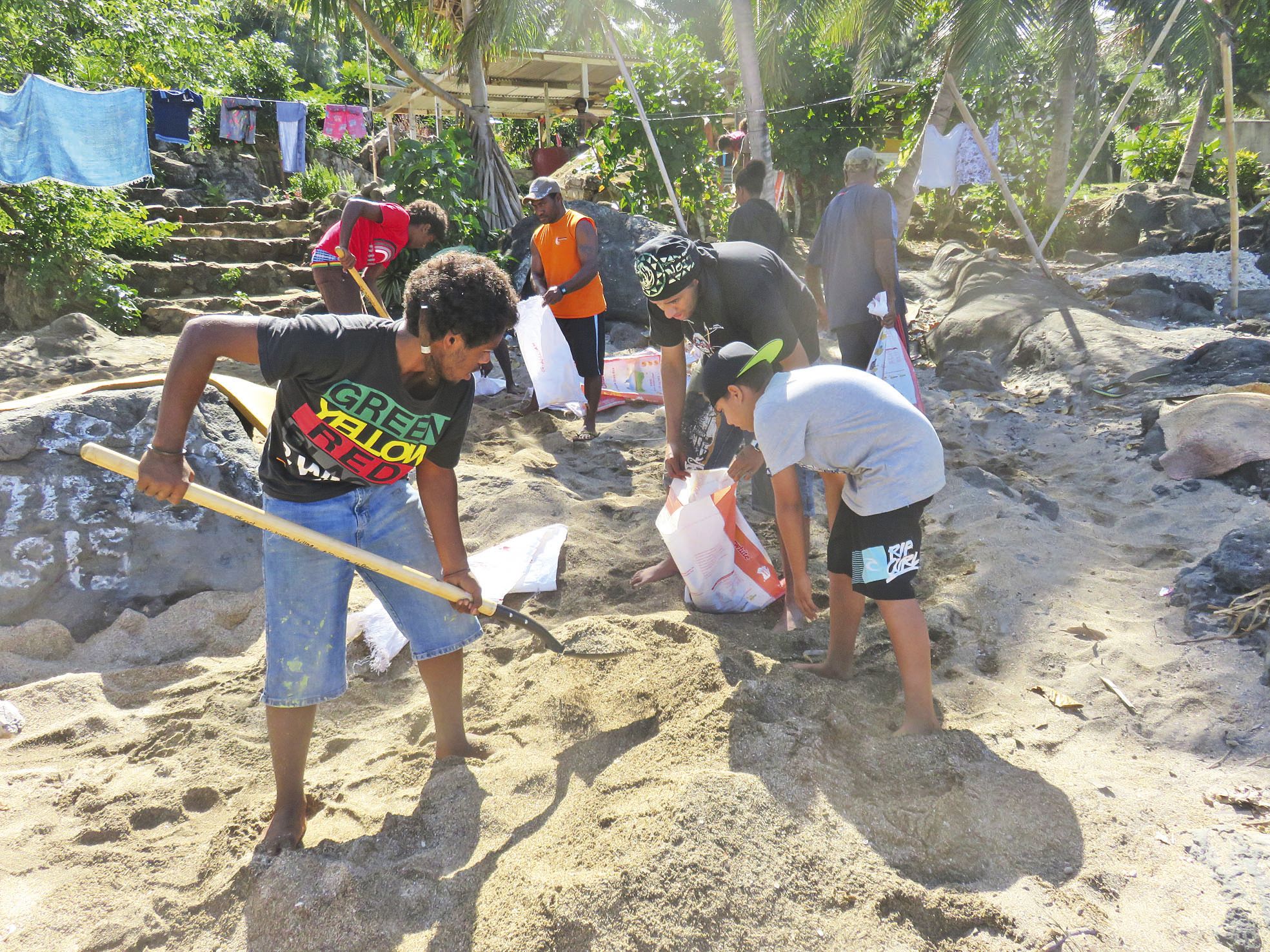 A Nguna, le ciment est préparé avec le sable collecté sur la plage. Ce qui nécessite  de remplir de lourds sacs, puis de les porter à dos d’homme sur le lieu du chantier.
