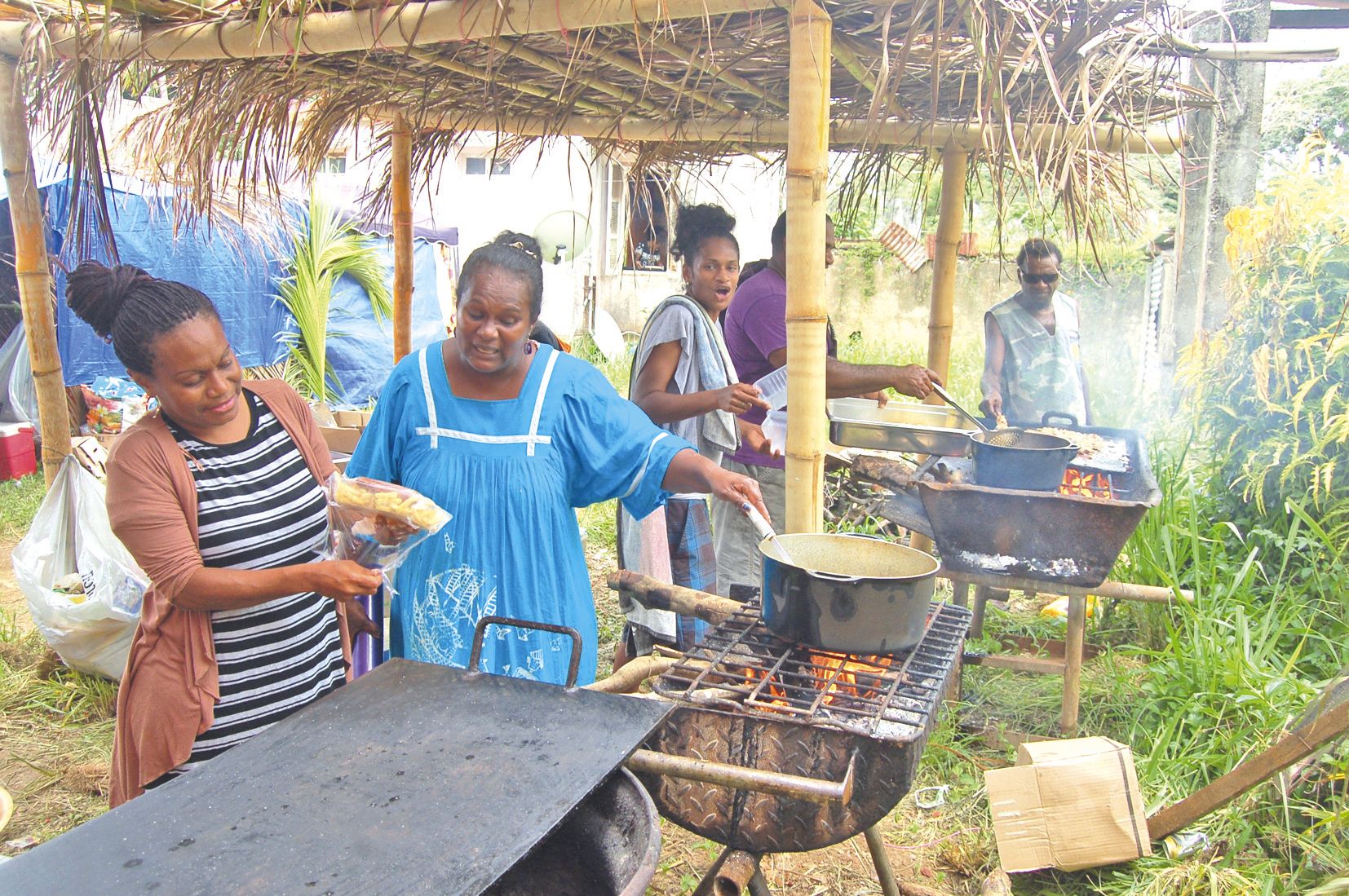 La majorité des stands de restauration ou de vente de divers produits étaient tenus par des habitants de la commune, comme ici dans la cuisine de la famille Parawi et de l’association Enfance et jeunesse de Houaïlou.
