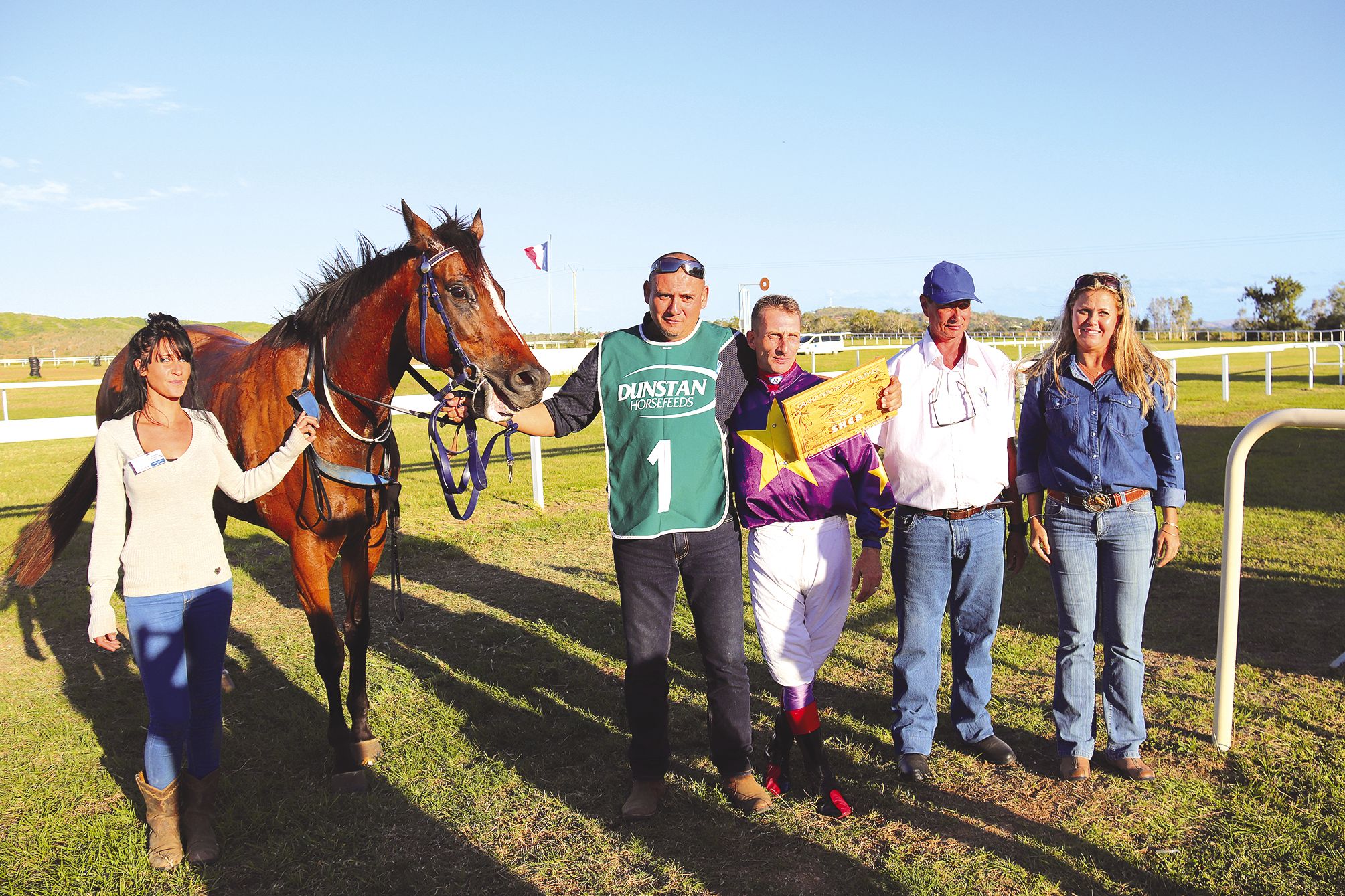 La jument Hooriya pose avec son jockey Régis Hacque (en violet), juste après les 2 200 mètres du Grand Prix de Boulouparis