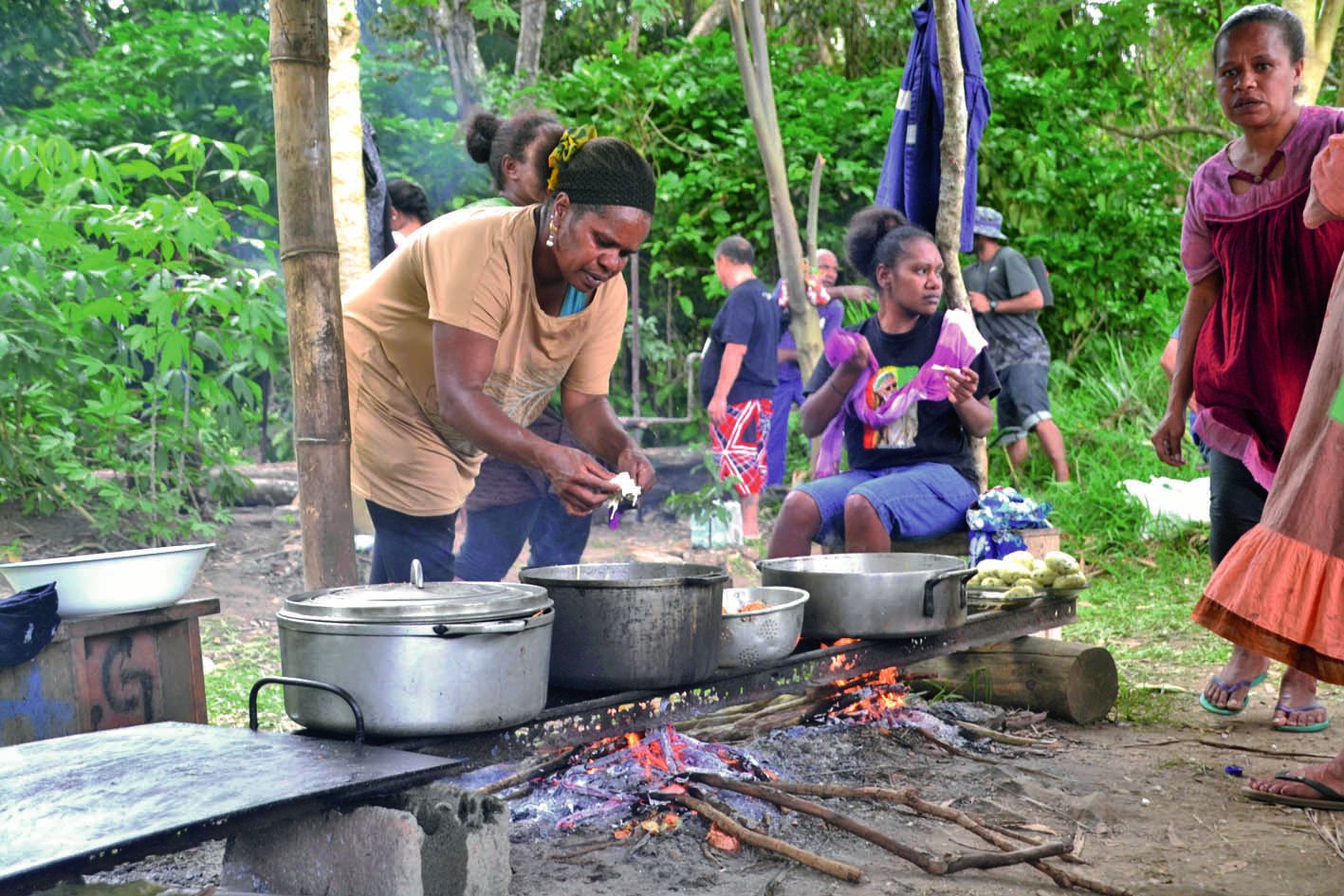 Un peu à l’écart des stands, les plats ont été préparés au feu de bois. Régina (à gauche) y faisait frire des « coquille long » enveloppées dans de la pâte impériale, « une recette qui a bien marché l’an dernier », dit-elle.